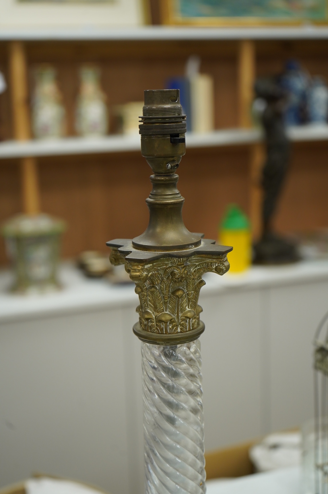 A pair of brass and glass Corinthian column lamps, 59cm high overall